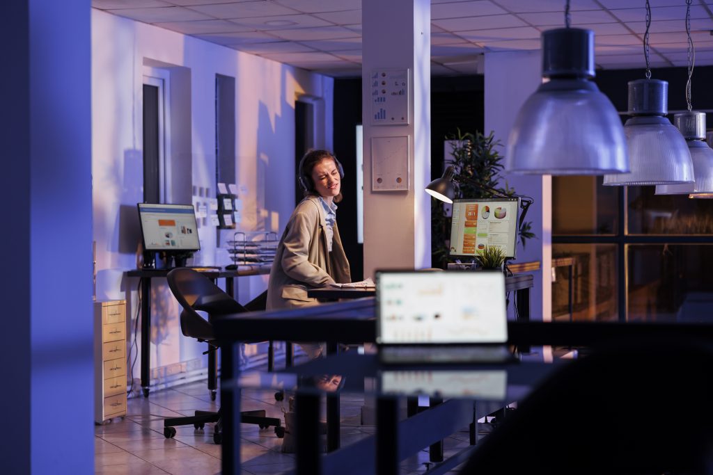 bases de l'équipement des salles de réunion ; Un employé d'entreprise portant un costume formel s'amuse dans un bureau de startup, écoutant de la musique et dansant pendant la pause de travail.